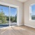 large room with wood floors and windows