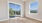 large room with wood floors and windows